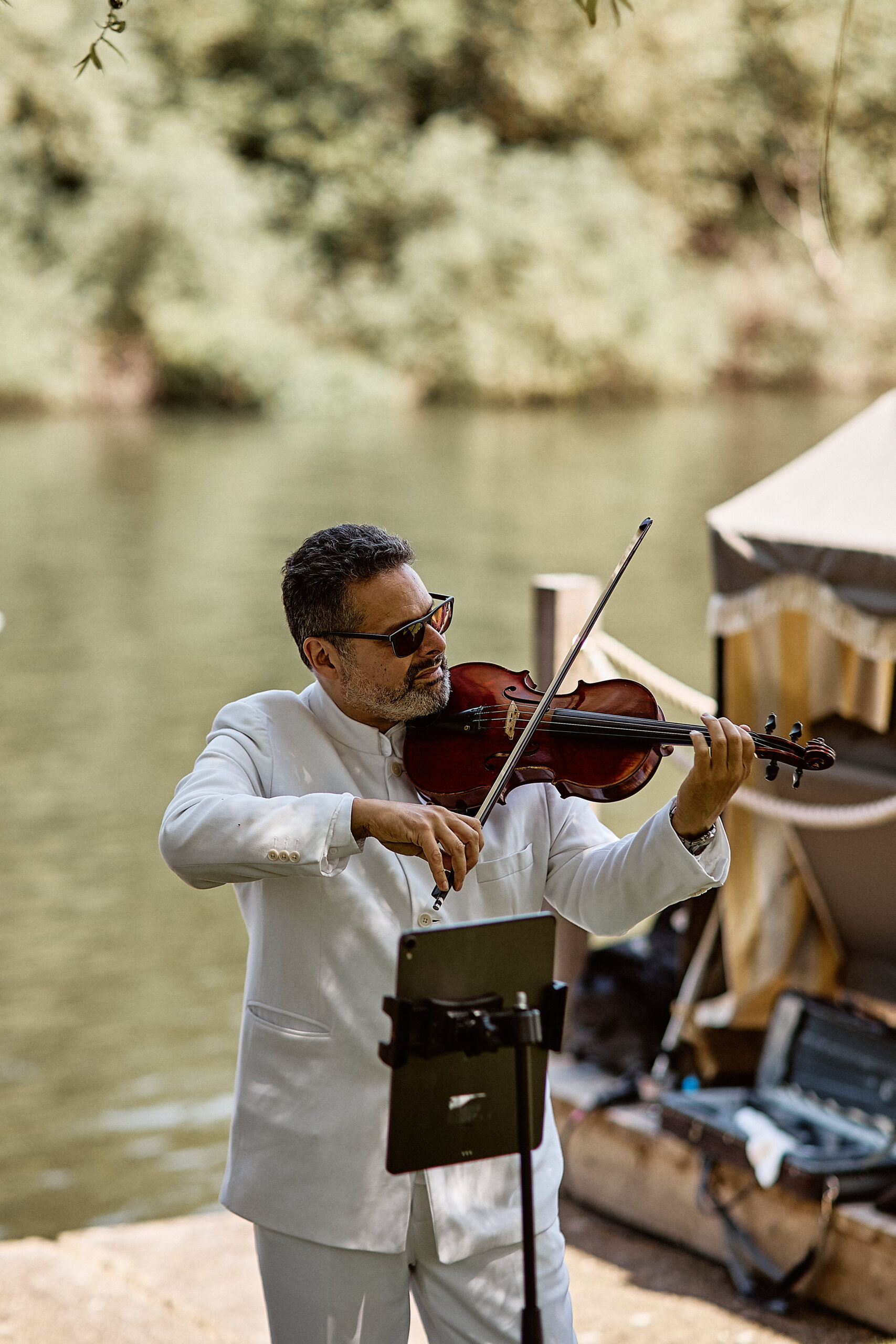 Stephen Hussey Solo Violin Live Performance Stephen Hussey performing solo violin outdoors beside a river.