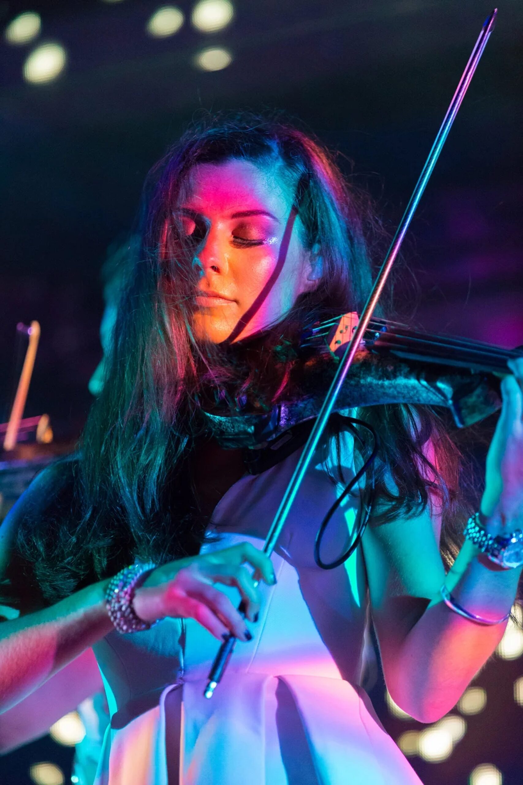 Electric String Quartet — Violinist Close-up of an electric violinist performing under coloured lighting