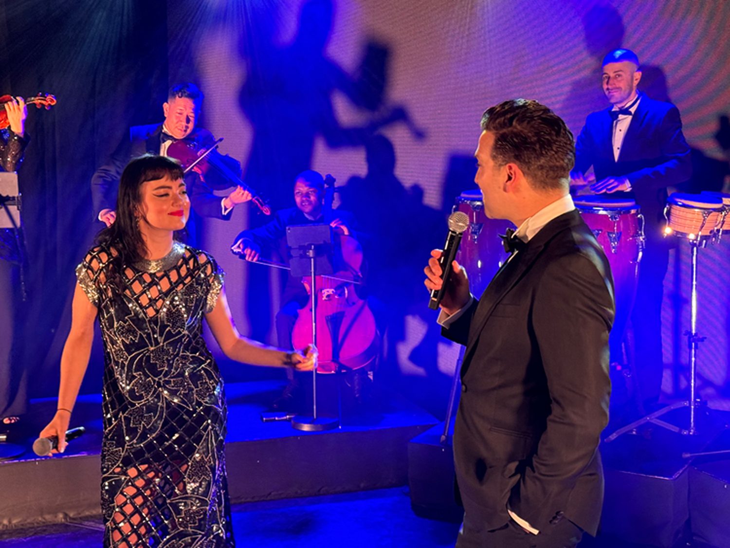 Swing Band — Vocal Duet Swing Band duet vocalists performing under blue stage lighting