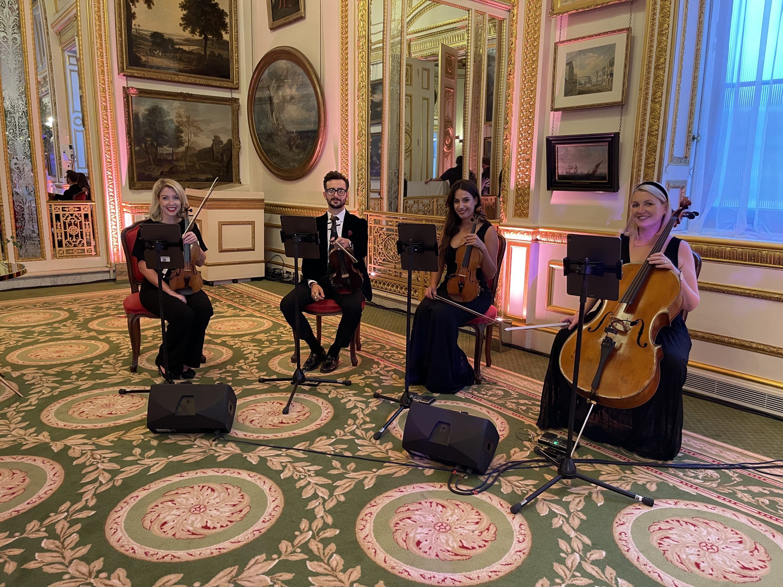 Classical String Quartet — Performance in a Grand Gilded Interior Urban Soul Orchestra string quartet performing in black formal dress in a gilded room with oil paintings and mirrors.